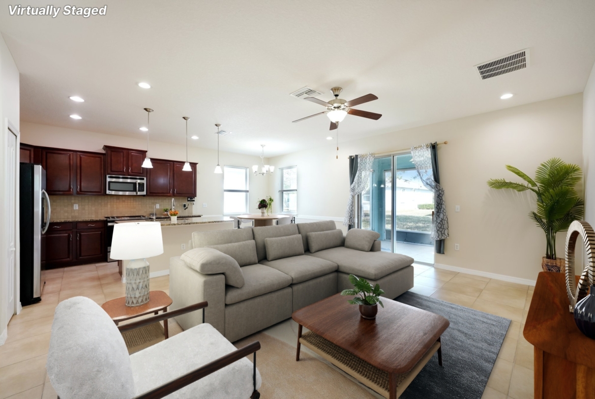 Open living room looking through to the kitchen at 11129 Kiskadee Cir, New Port Richey FL