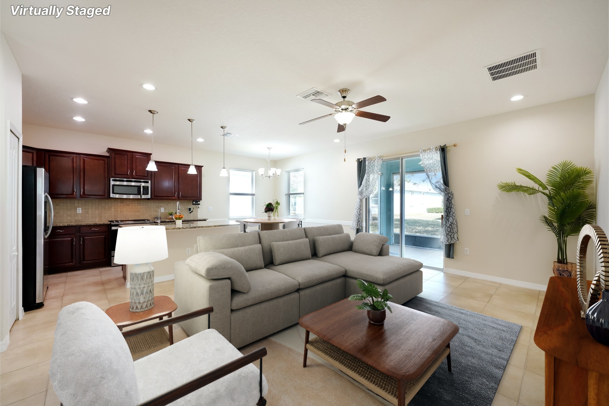 Open living room looking through to the kitchen at 11129 Kiskadee Cir, New Port Richey FL