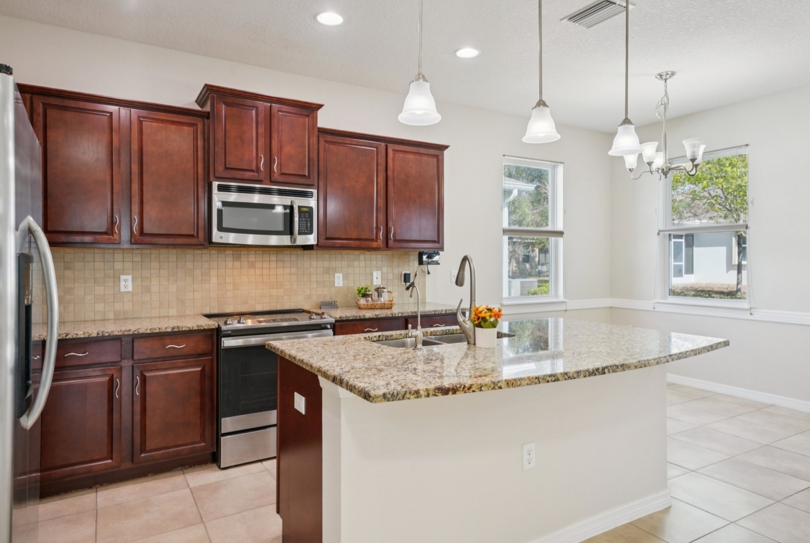 Kitchen with granite counters, stainless steel appliances and a large island in New Port Richey FL 34654