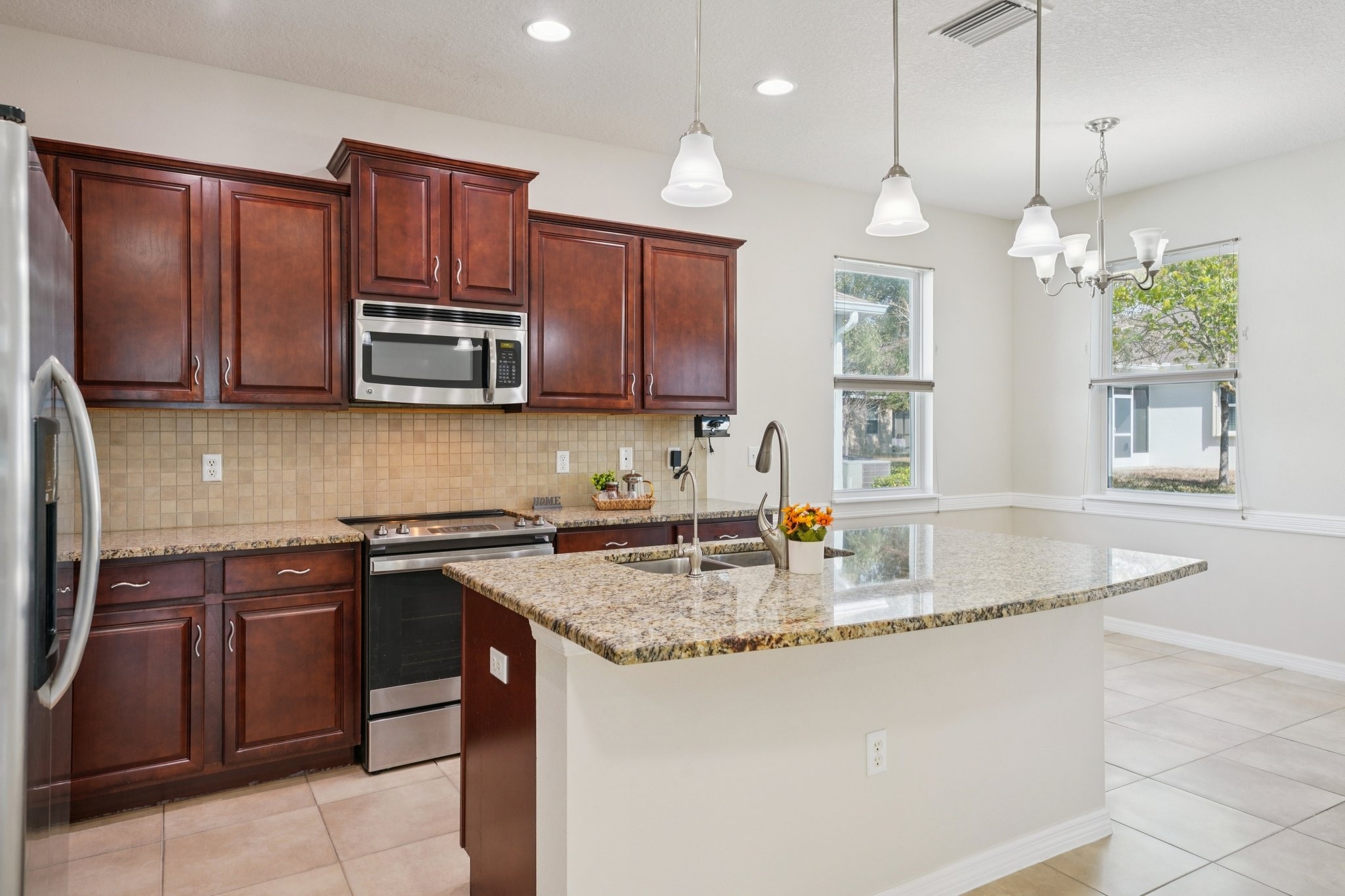 Kitchen with granite counters, stainless steel appliances and a large island in New Port Richey FL 34654