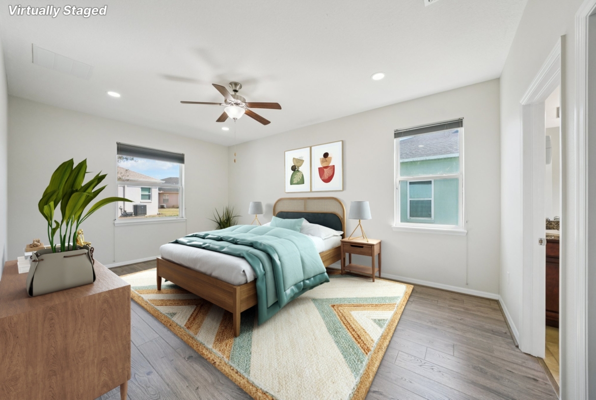 Primary bedroom with ceiling fan and natural light at 11129 Kiskadee Cir, New Port Richey FL