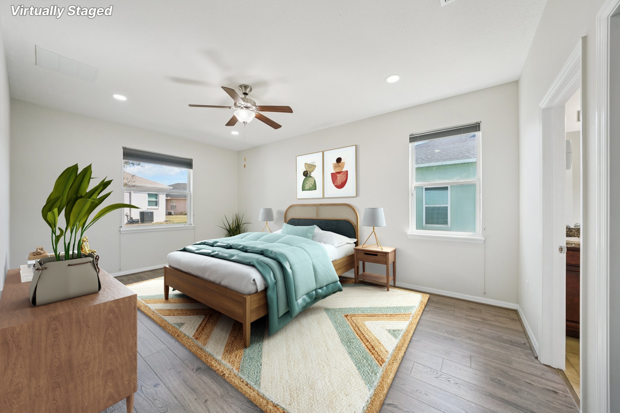 Primary bedroom with ceiling fan and natural light at 11129 Kiskadee Cir, New Port Richey FL