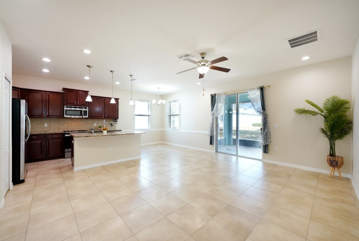 Living area with sliding doors to the screened lanai and tile flooring, New Port Richey FL