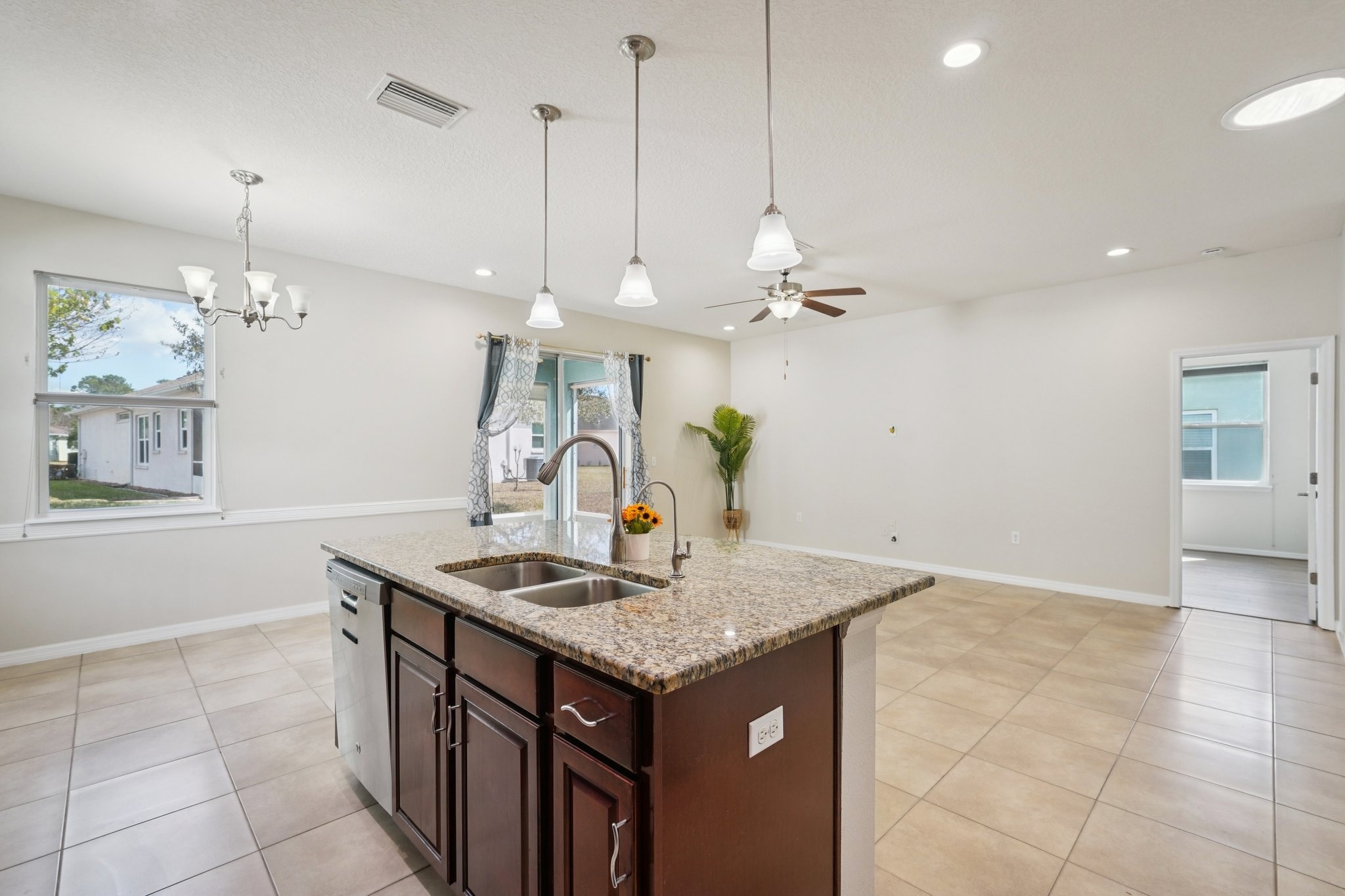 Kitchen with cozy eat-in dinette and granite counters in this 55+ New Port Richey home for sale