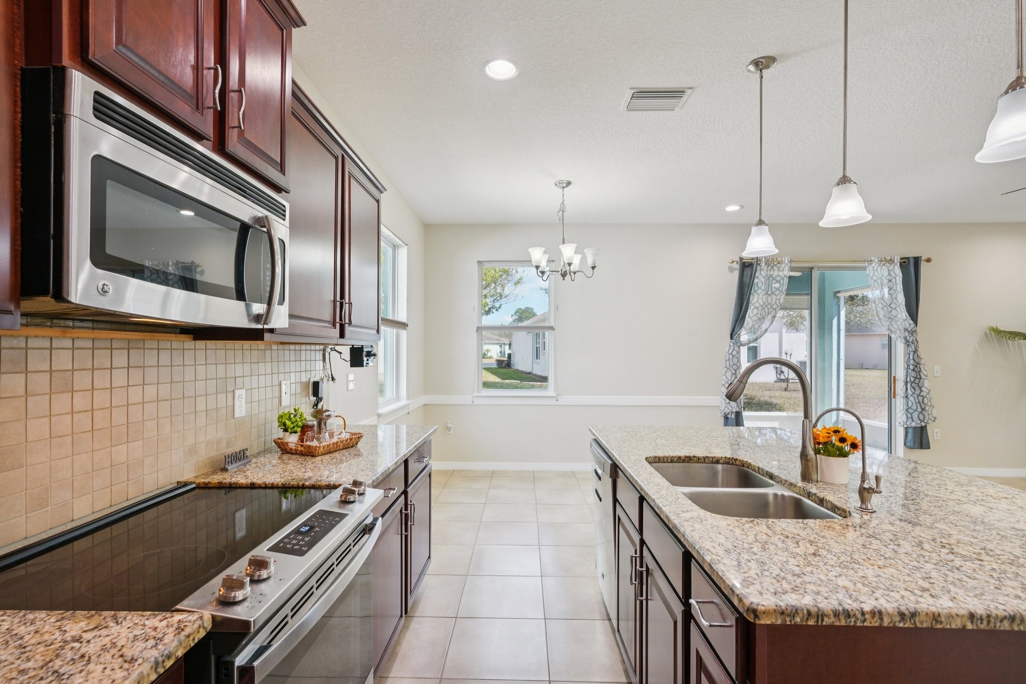Kitchen with stainless range, microwave and double sink at 11129 Kiskadee Cir, New Port Richey FL