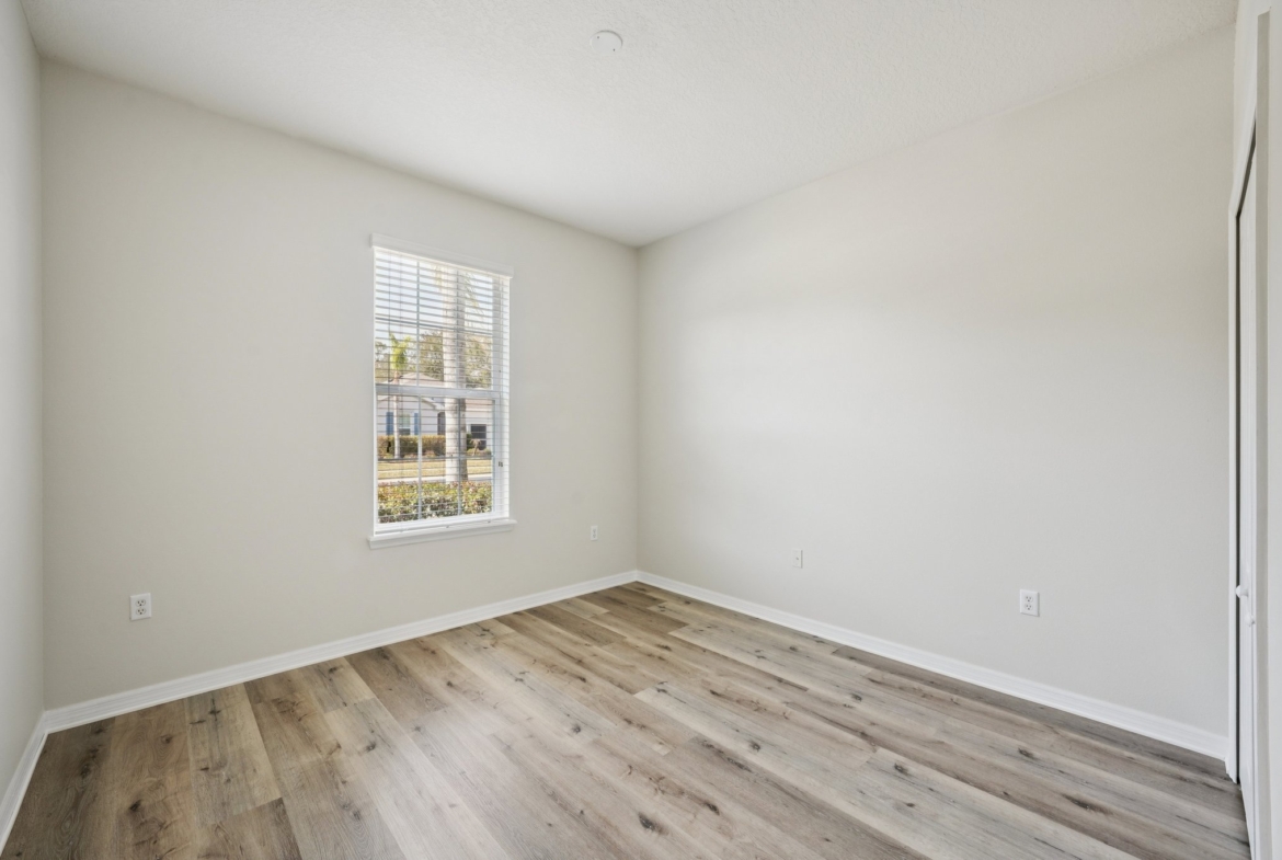 Third bedroom with window treatments at 11129 Kiskadee Cir, New Port Richey FL 34654