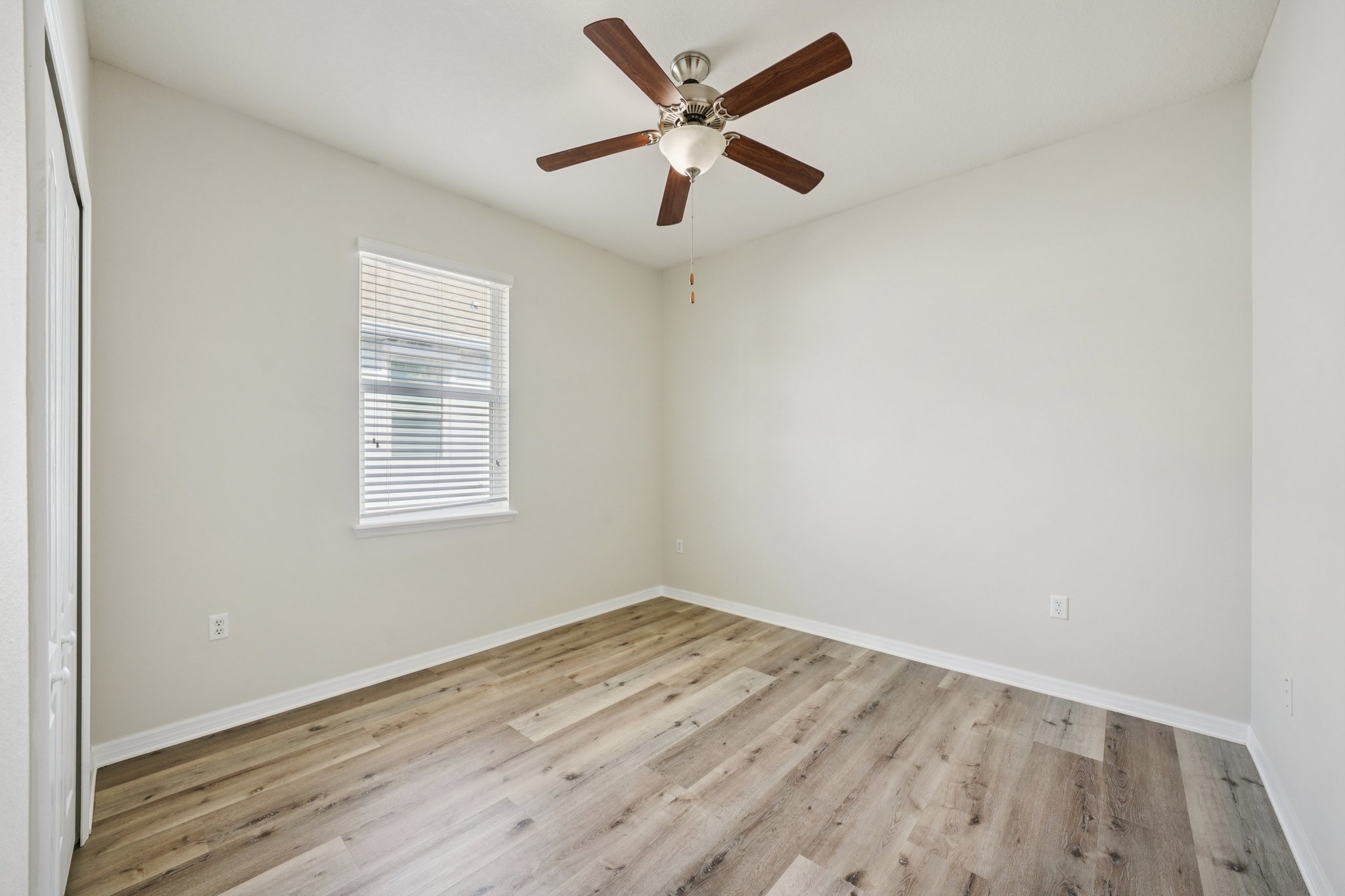 Bedroom with ceiling fan and window treatments at 11129 Kiskadee Cir, New Port Richey FL