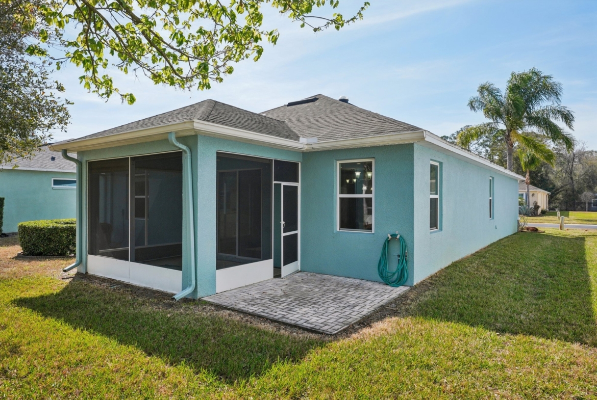 Rear exterior with screened lanai at 11129 Kiskadee Cir, New Port Richey FL