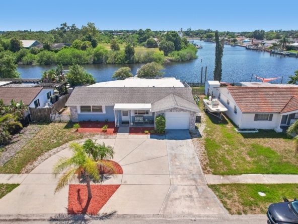 Aerial view of 1133 Grand Blvd, a waterfront home for sale with private dock and direct Gulf access in Holiday, FL 34690