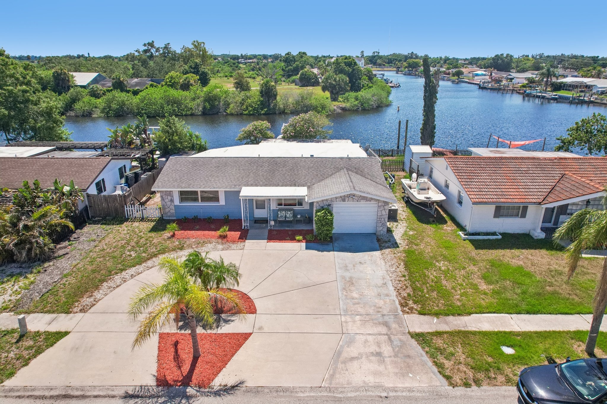 Aerial view of 1133 Grand Blvd, a waterfront home for sale with private dock and direct Gulf access in Holiday, FL 34690