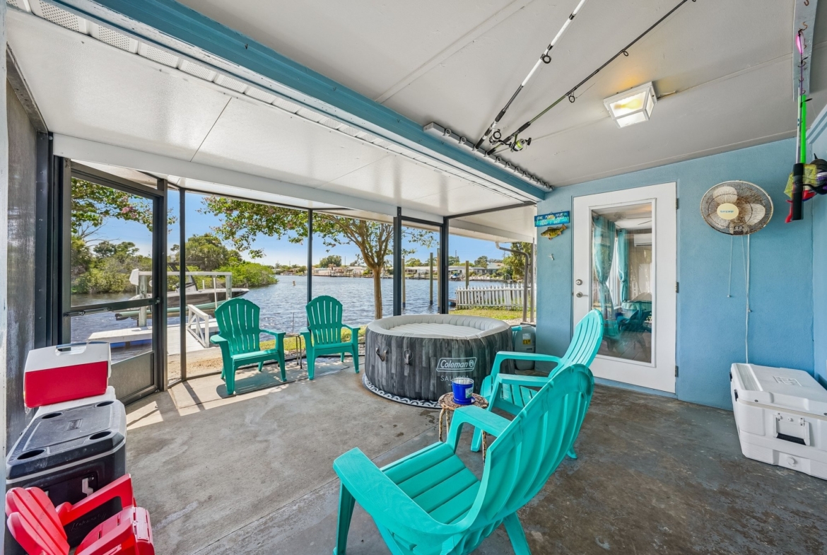 Expansive wrap-around screened lanai overlooking the water at 1133 Grand Blvd, Holiday FL