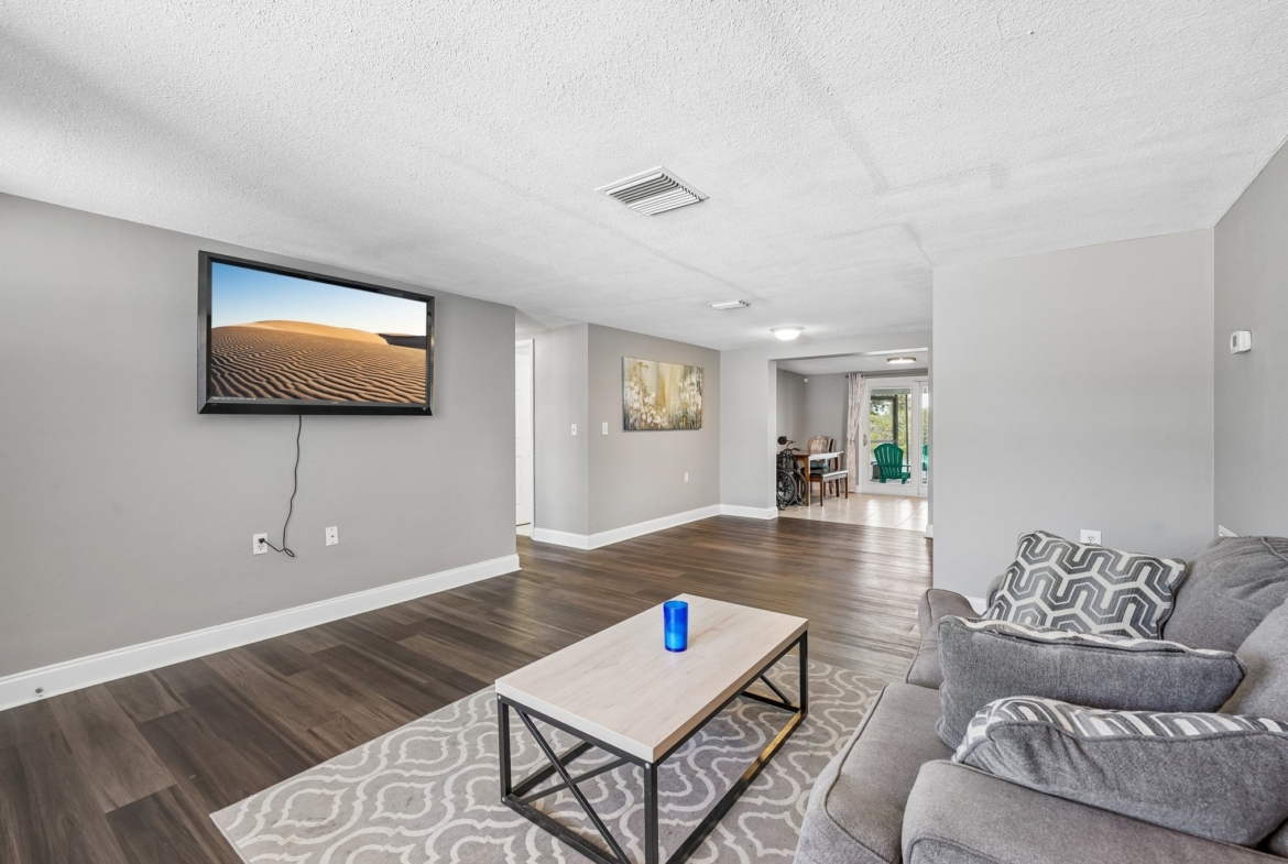 Open living room dining room combo with fresh paint and insulated windows in this Holiday FL waterfront home