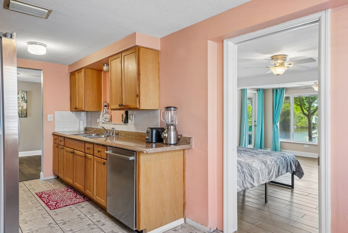 Eat-in kitchen with dishwasher and stone counters at 1133 Grand Blvd, Holiday FL
