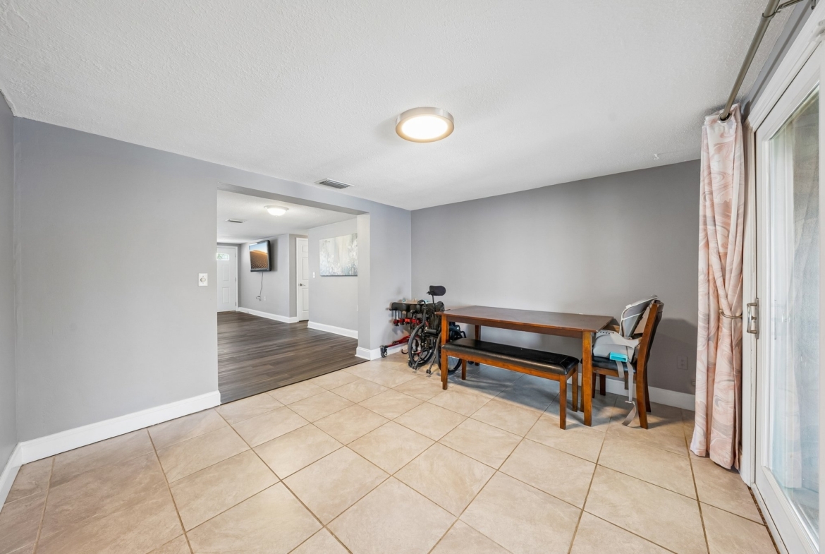 Dining area with tile flooring in this waterfront ranch home for sale in Holiday FL