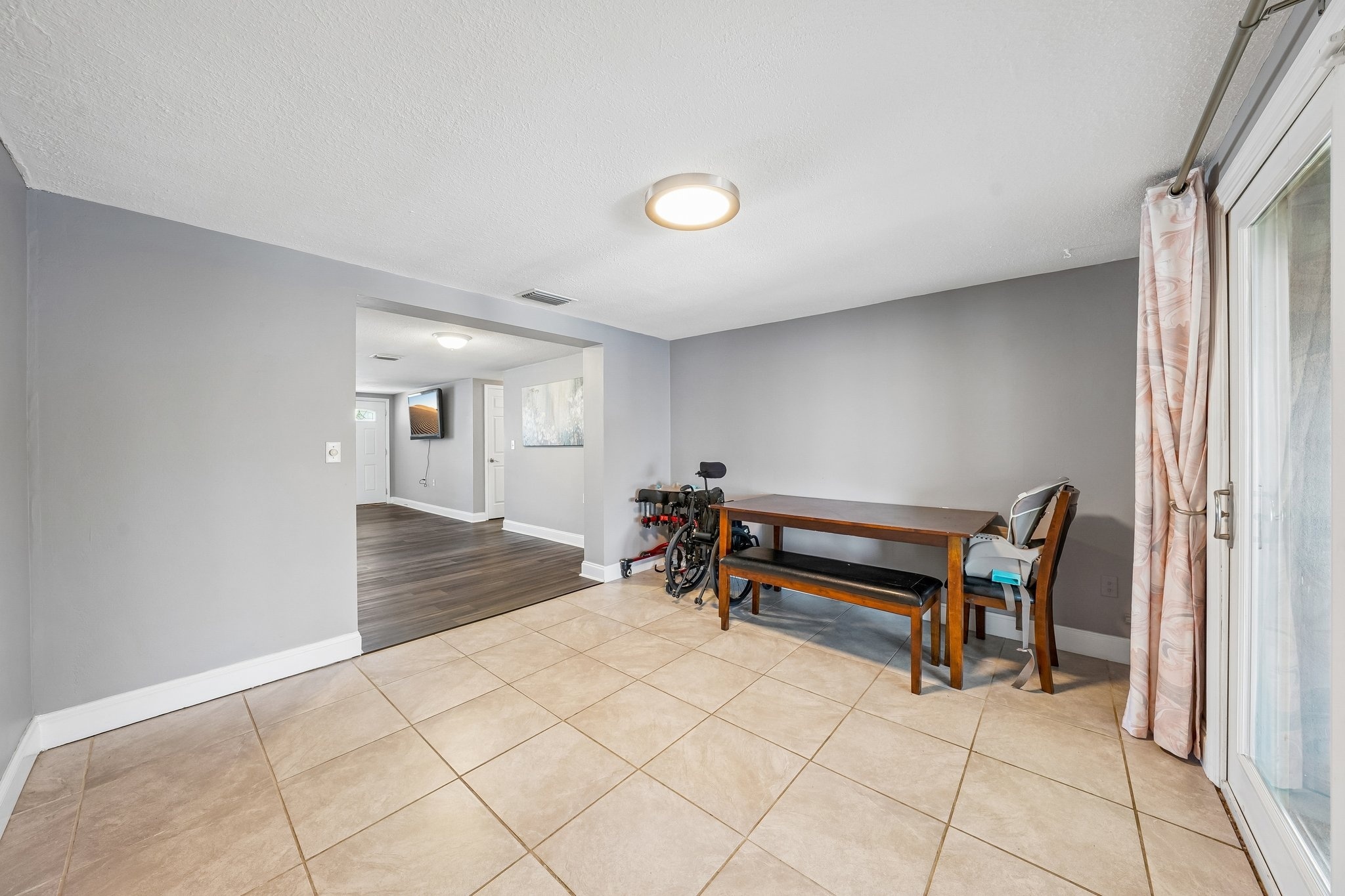 Dining area with tile flooring in this waterfront ranch home for sale in Holiday FL