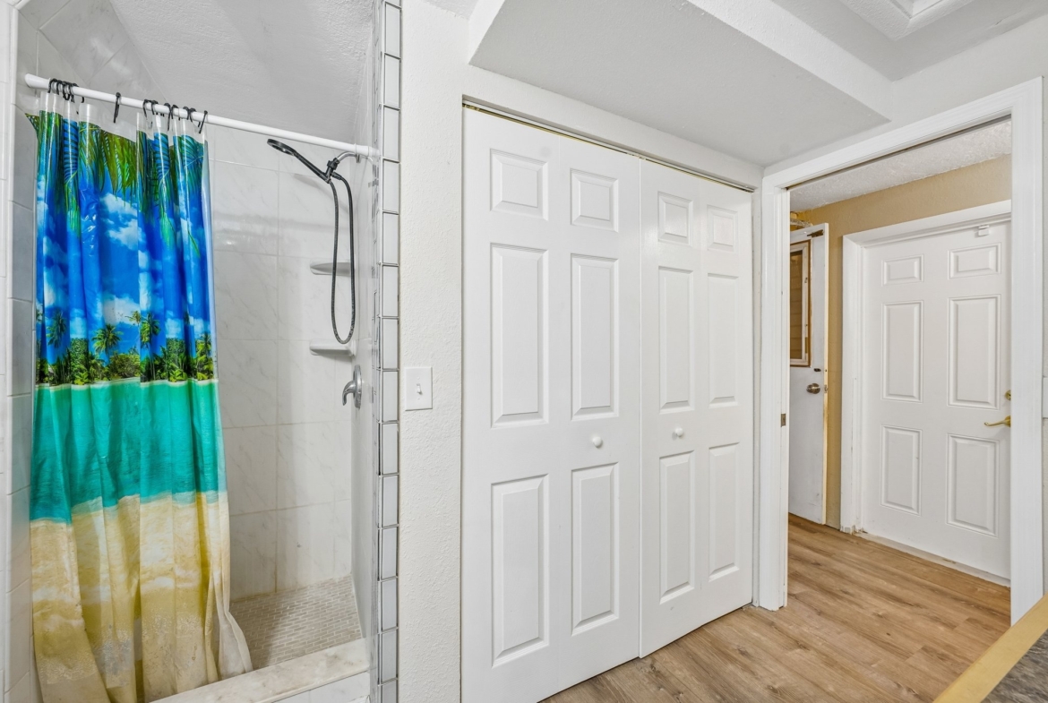 Renovated bathroom with walk-in shower and glass backsplash at 1133 Grand Blvd, Holiday FL