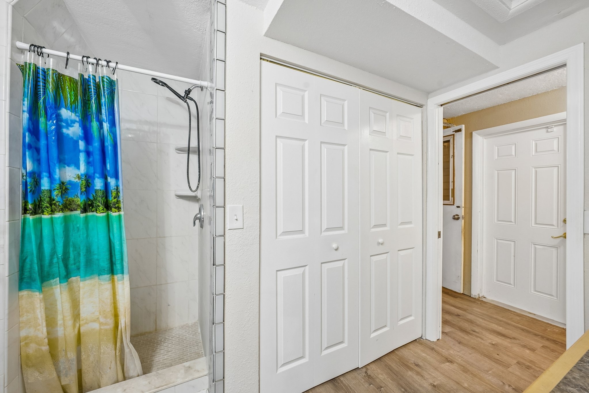 Renovated bathroom with walk-in shower and glass backsplash at 1133 Grand Blvd, Holiday FL