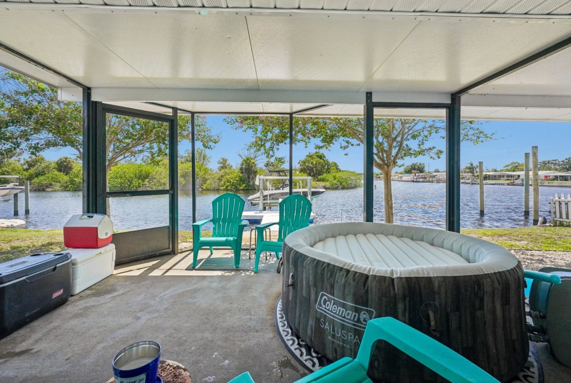 Screened lanai with hot tub overlooking the Anclote River at 1133 Grand Blvd, Holiday FL