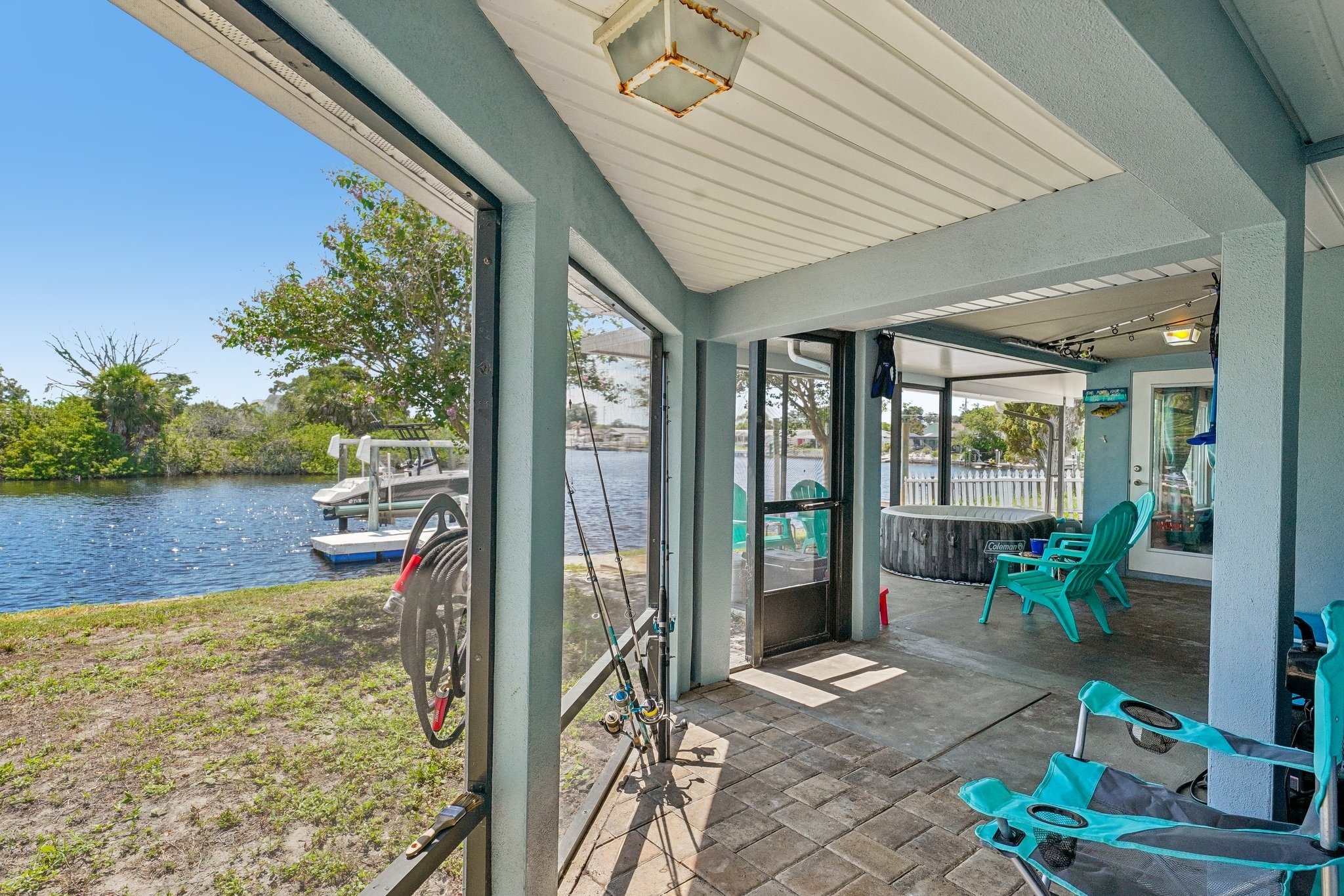 View from the wrap-around screened lanai out to the private dock and boat lift, Holiday FL 34690
