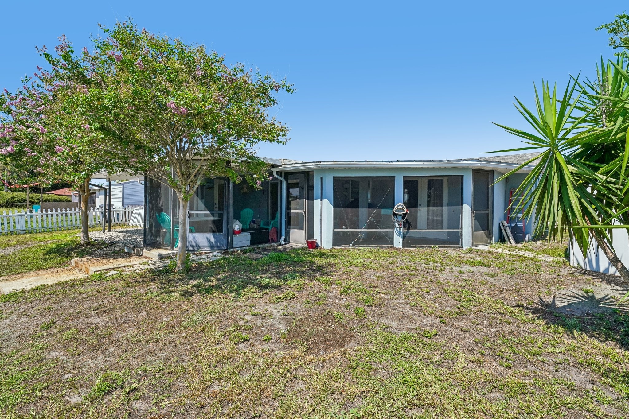 Fenced green space and updated landscaping behind this Holiday FL waterfront home for sale