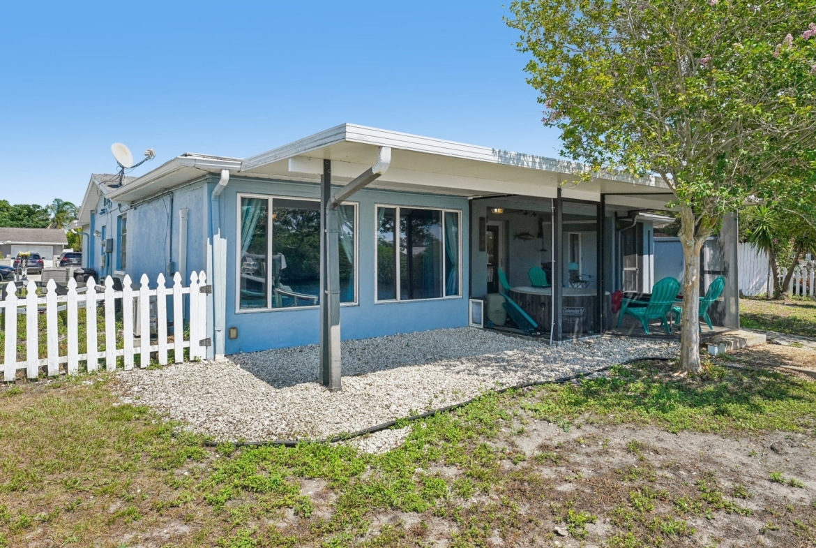 Rear exterior with expansive wrap-around screened lanai at 1133 Grand Blvd, Holiday FL