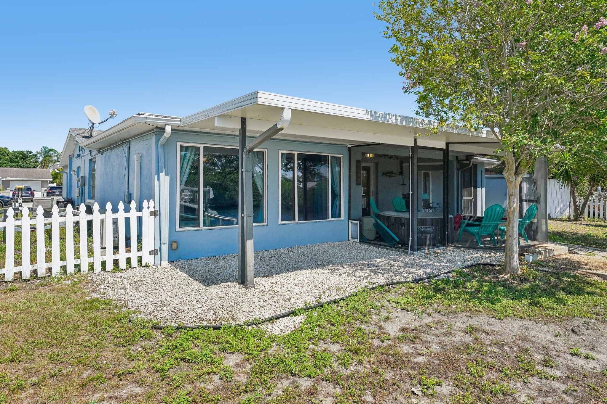 Rear exterior with expansive wrap-around screened lanai at 1133 Grand Blvd, Holiday FL