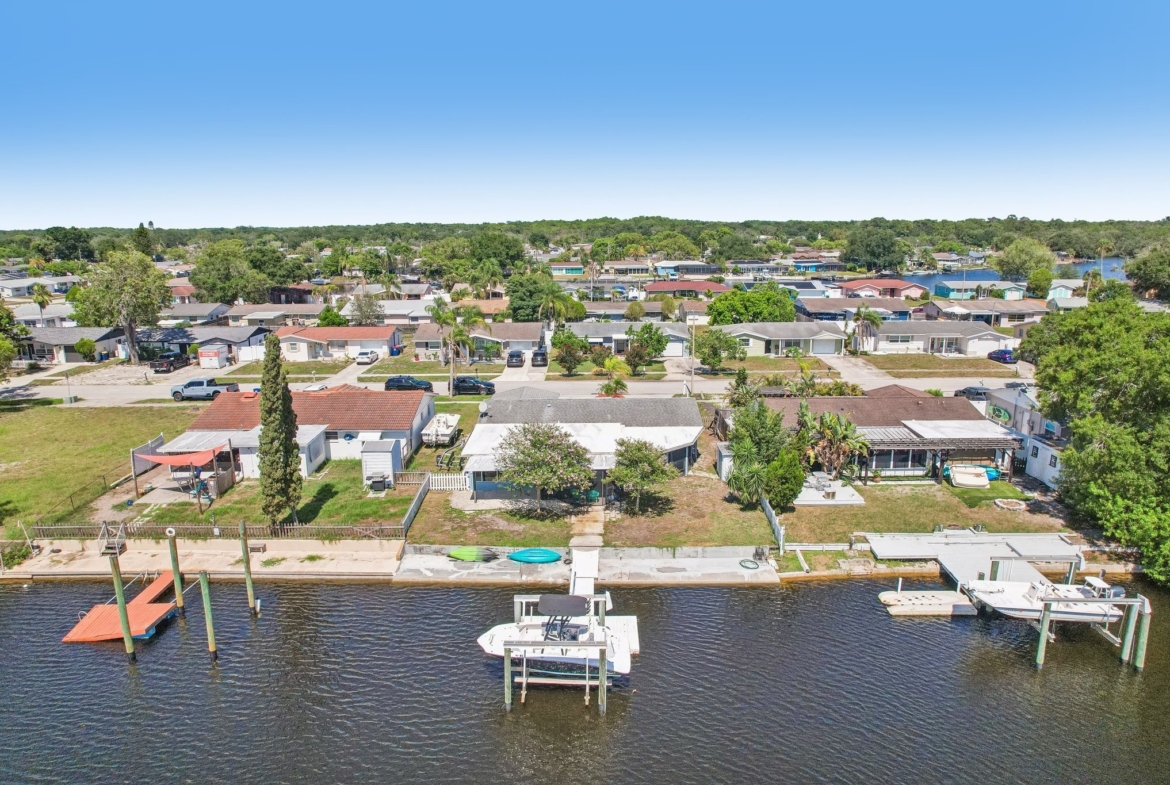 Aerial of the home, private dock and boat lift on the water in Holiday, FL 34690