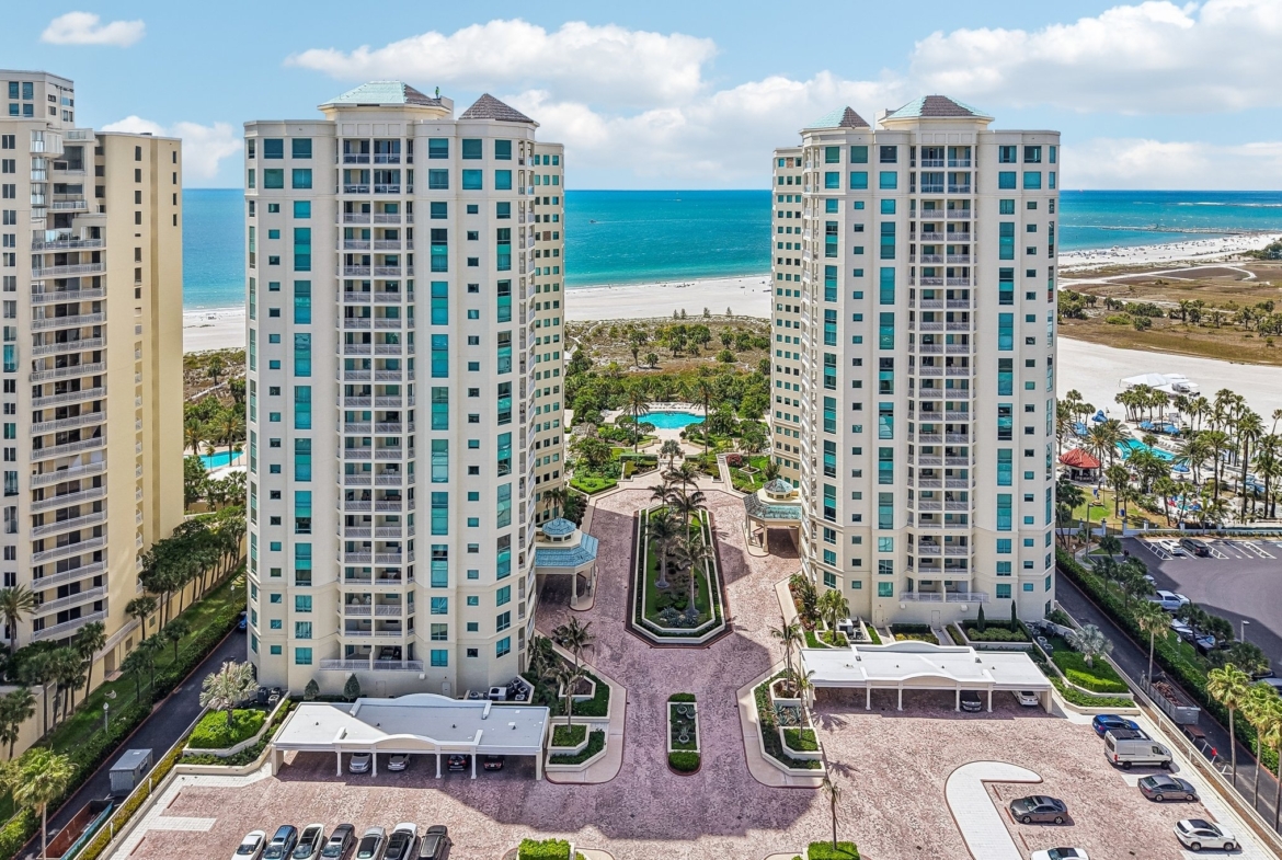 Aerial view of The Grande on Sand Key luxury condo towers on the Gulf of Mexico in Clearwater Beach, FL 33767