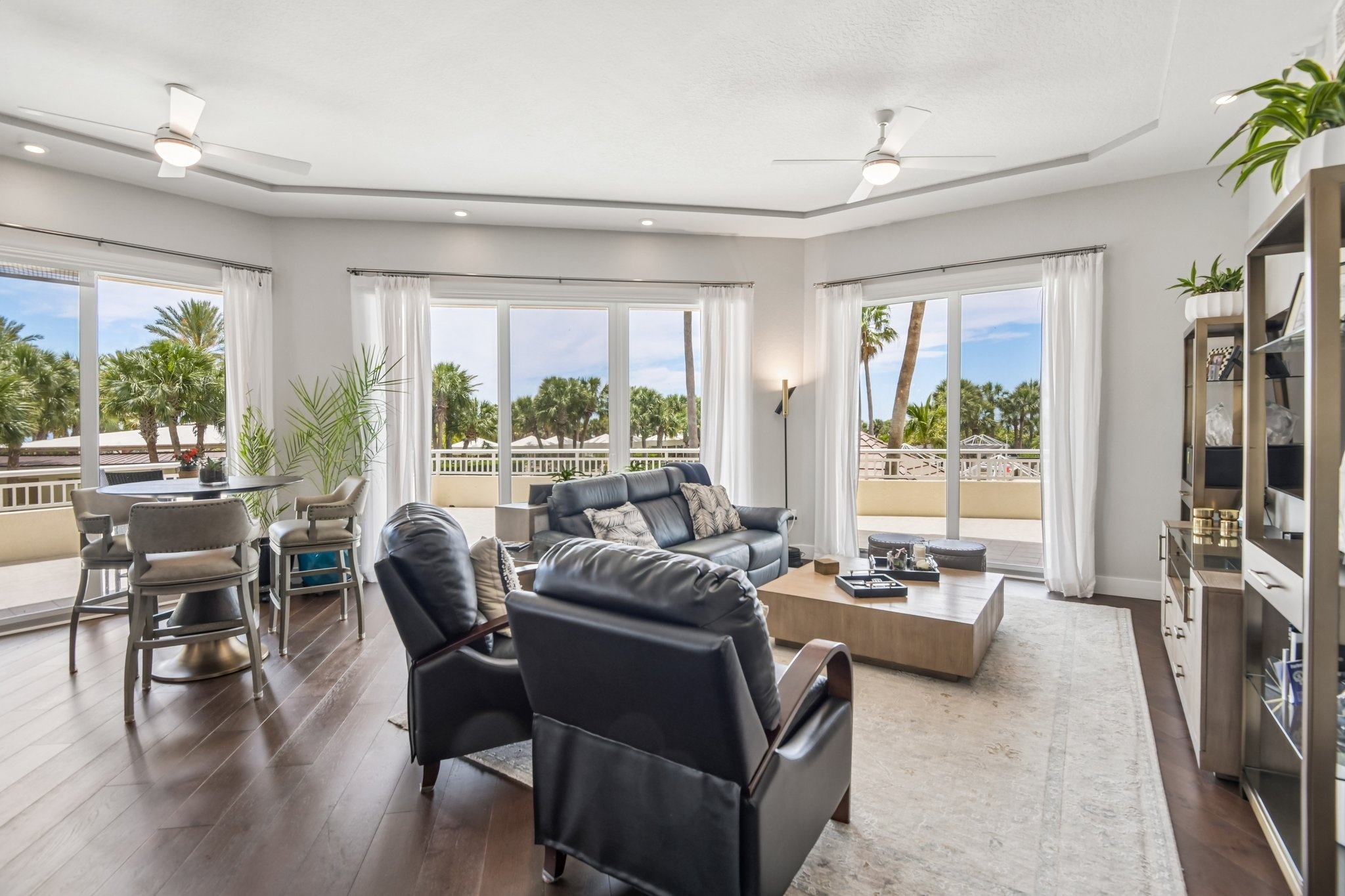 Living room with a wall of windows and Gulf views at 1180 Gulf Blvd #101, The Grande on Sand Key, Clearwater Beach FL