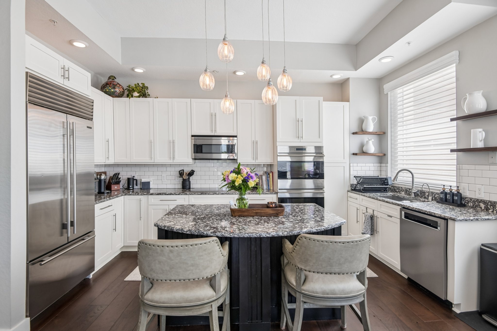 Gourmet kitchen with 42-inch cabinetry, stone counters and a large island at The Grande on Sand Key residence 101