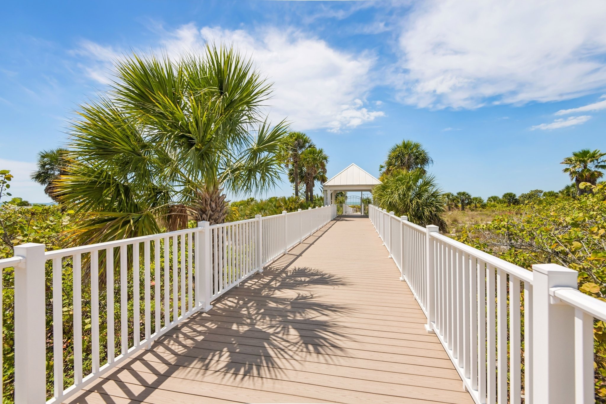Private boardwalk leading to the sugar-white sand beach at The Grande on Sand Key, Clearwater Beach FL