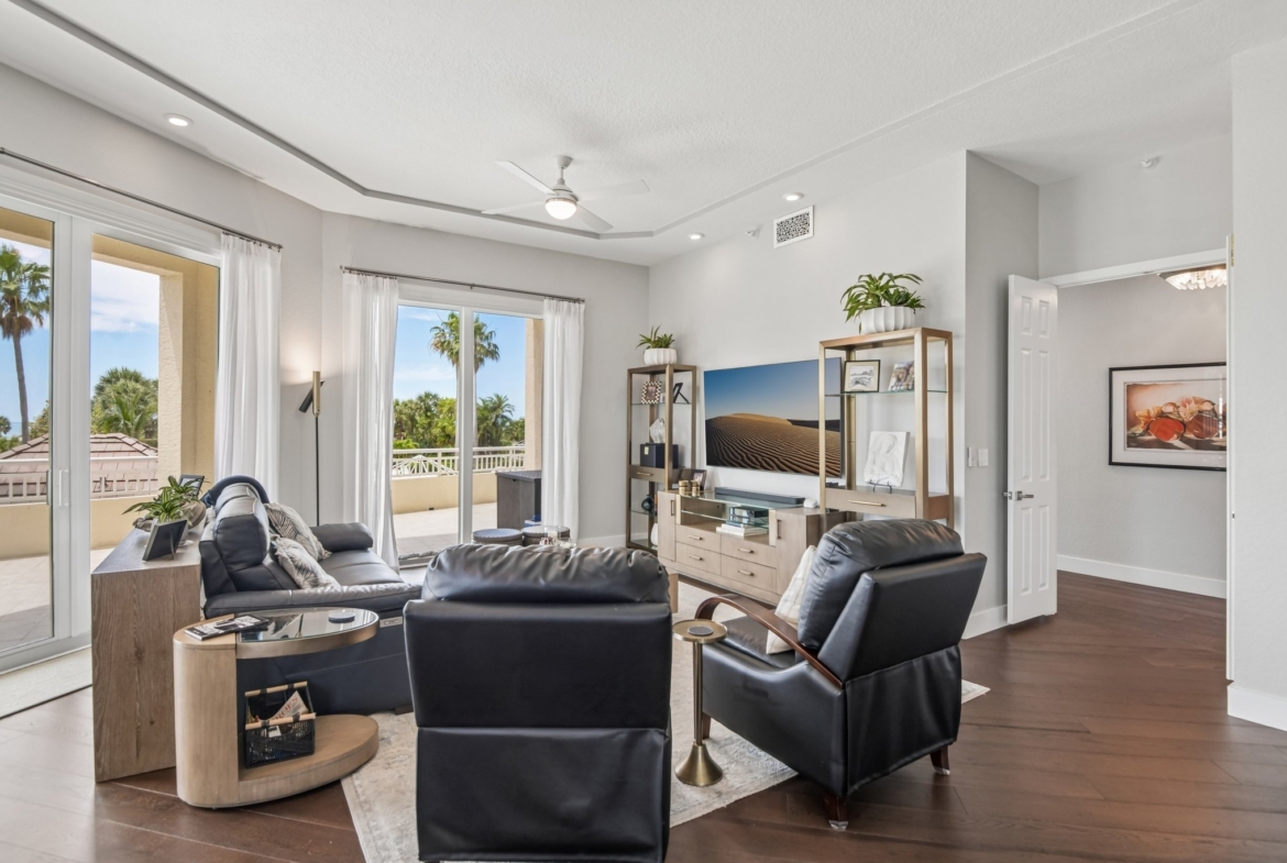 Living room seating area with 12-foot ceilings and automated window treatments at The Grande on Sand Key