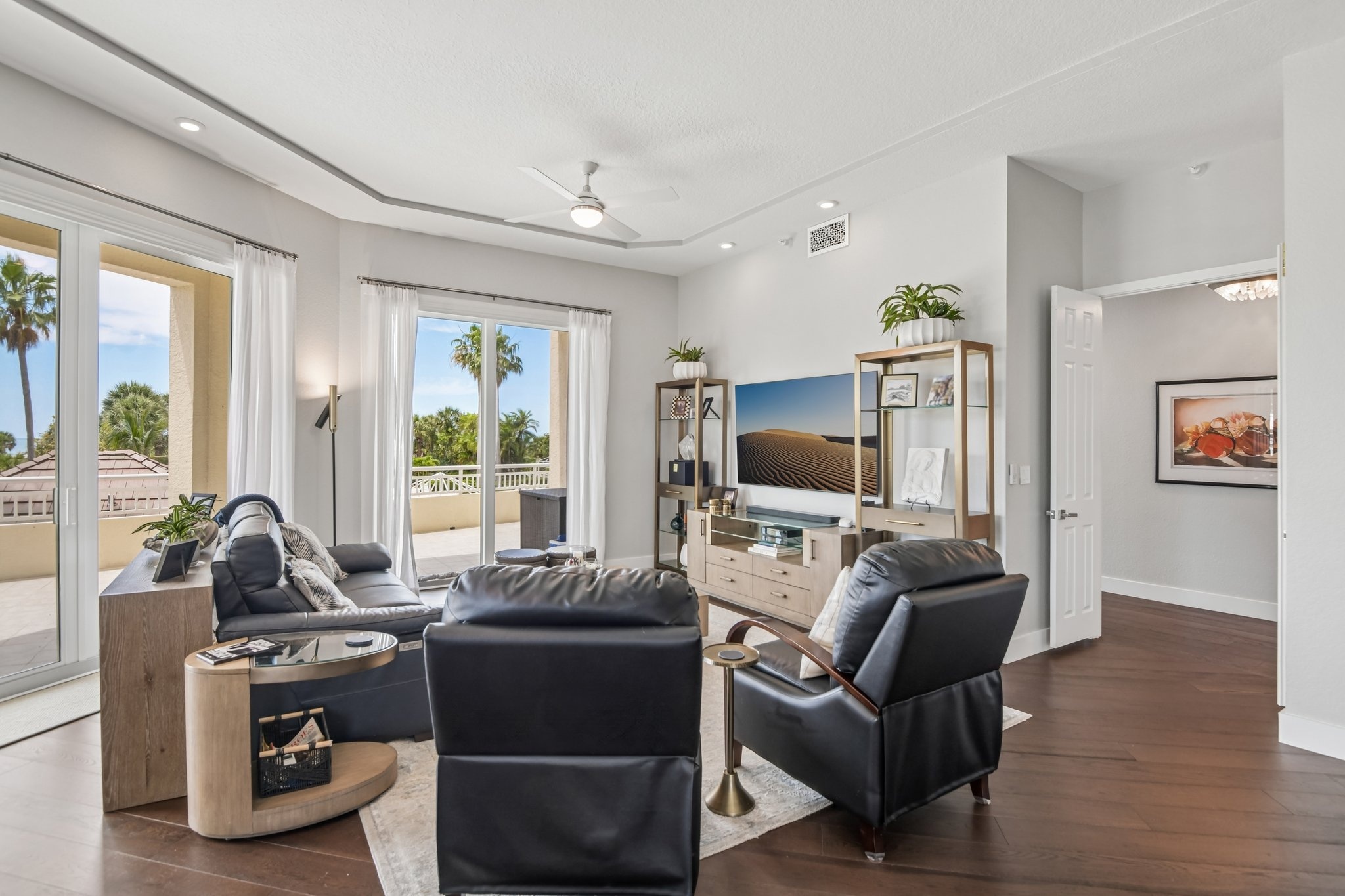 Living room seating area with 12-foot ceilings and automated window treatments at The Grande on Sand Key