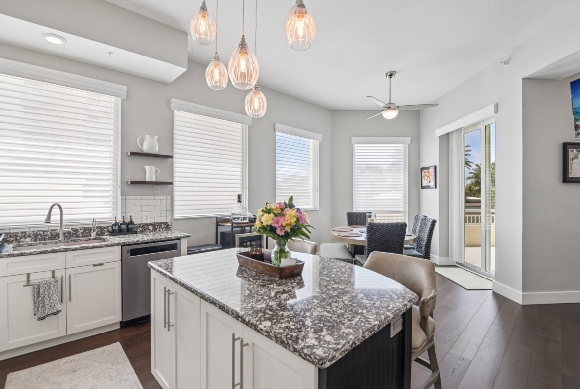 Kitchen island with pendant lighting and eat-in seating in this 3 bedroom Clearwater Beach condo for sale