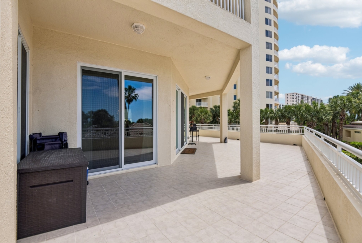 Terrace access through sliding glass doors from the living area at The Grande on Sand Key residence 101