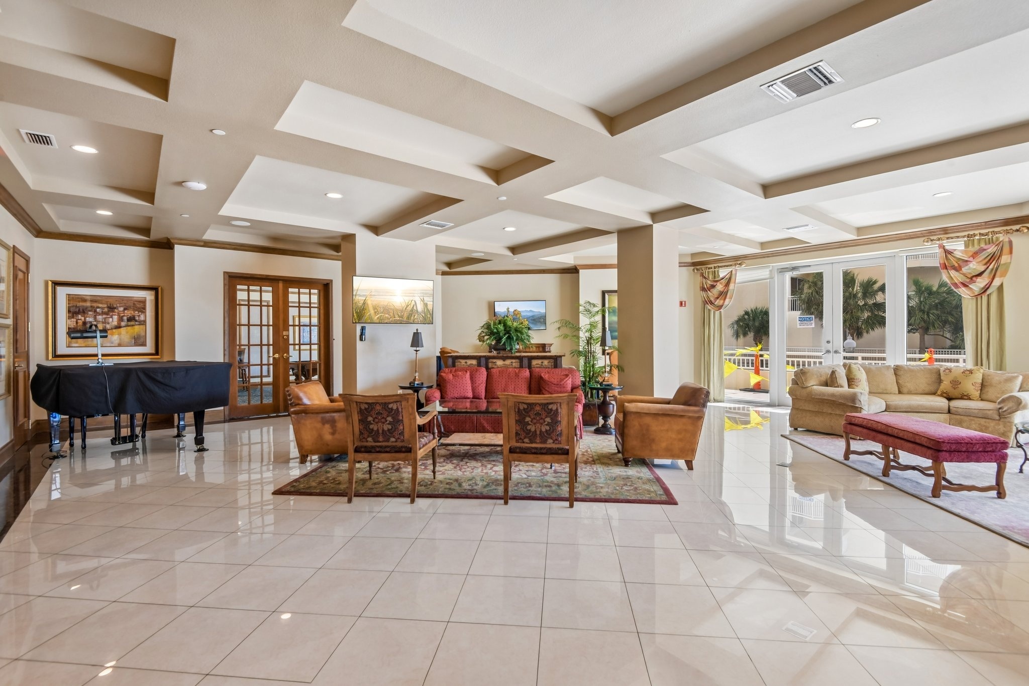 Elegant lobby social room with coffered ceilings at The Grande on Sand Key condominium