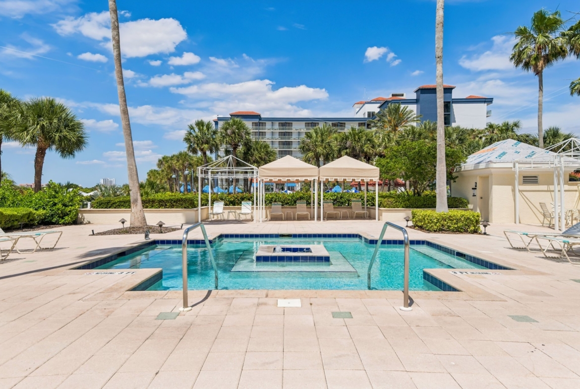 Resort-style heated gunite pool with private gazebos at The Grande on Sand Key, Clearwater Beach FL