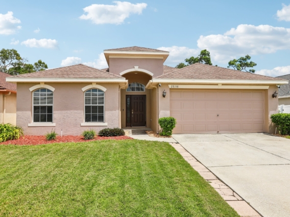 Front exterior of 2638 Big Pine Dr, a 3 bedroom home for sale in the gated Key Vista community of Holiday, FL 34691