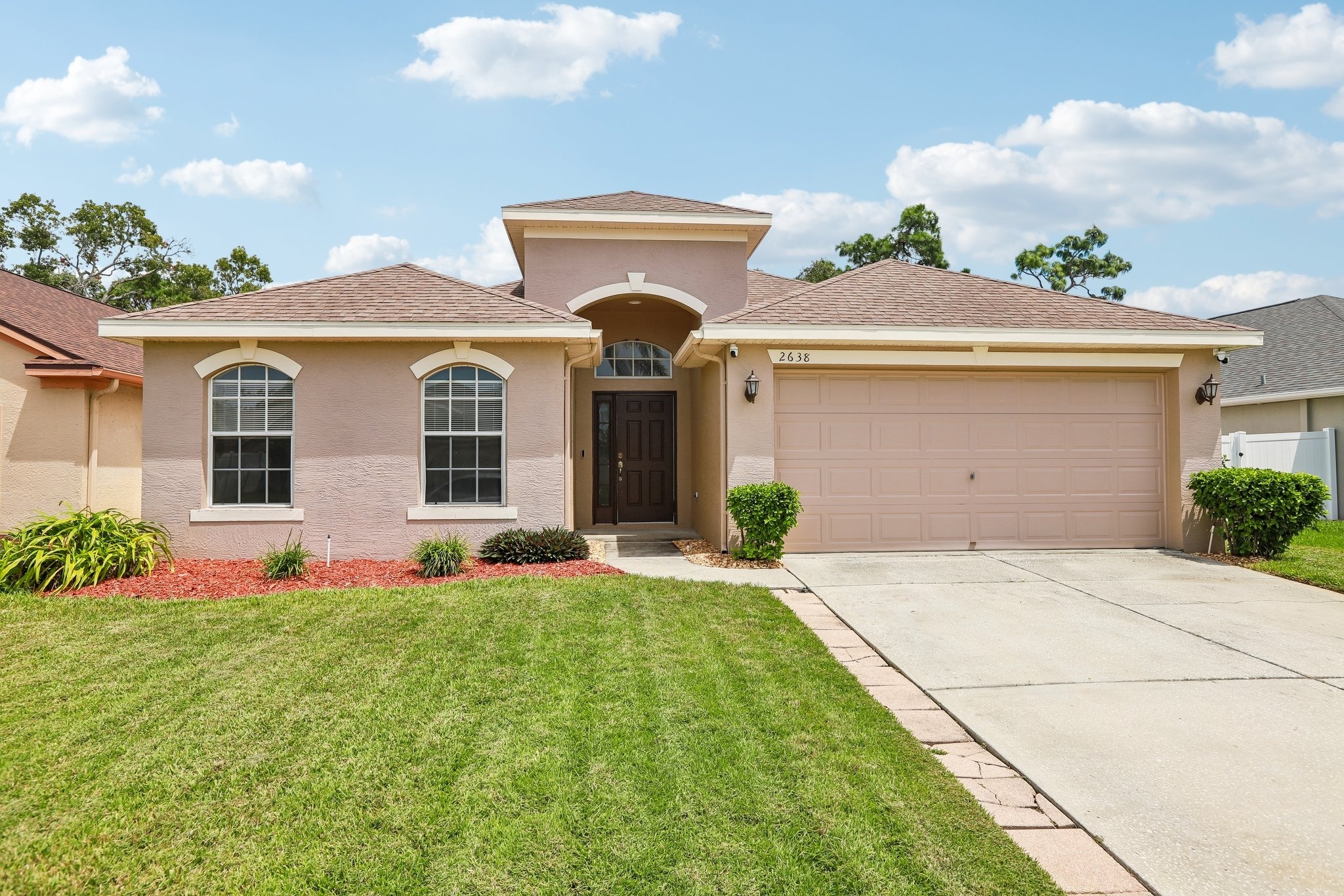 Front exterior of 2638 Big Pine Dr, a 3 bedroom home for sale in the gated Key Vista community of Holiday, FL 34691