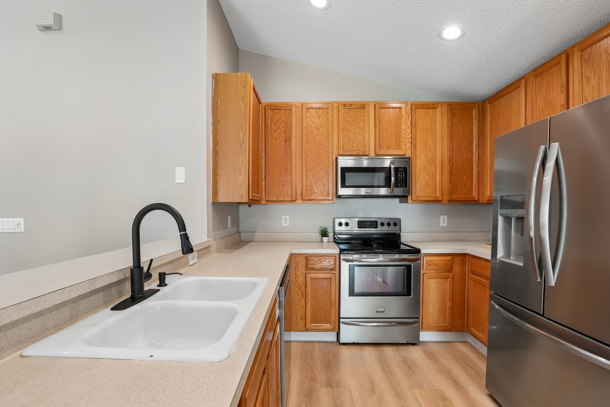 Kitchen sink with modern faucet, stainless range and microwave at 2638 Big Pine Dr, Holiday FL
