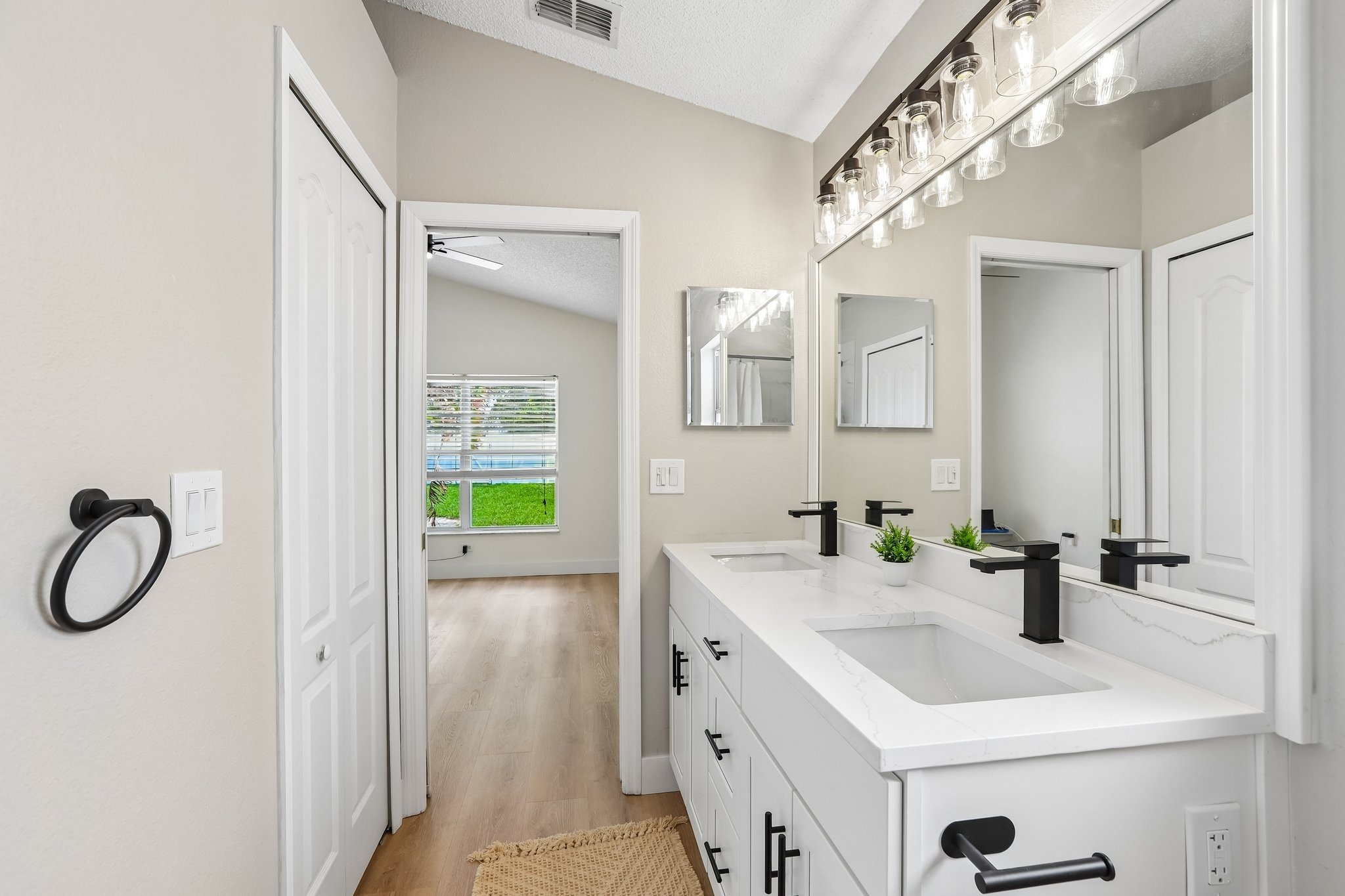 Primary bathroom with modern dual vanity and matte black fixtures at 2638 Big Pine Dr, Holiday FL