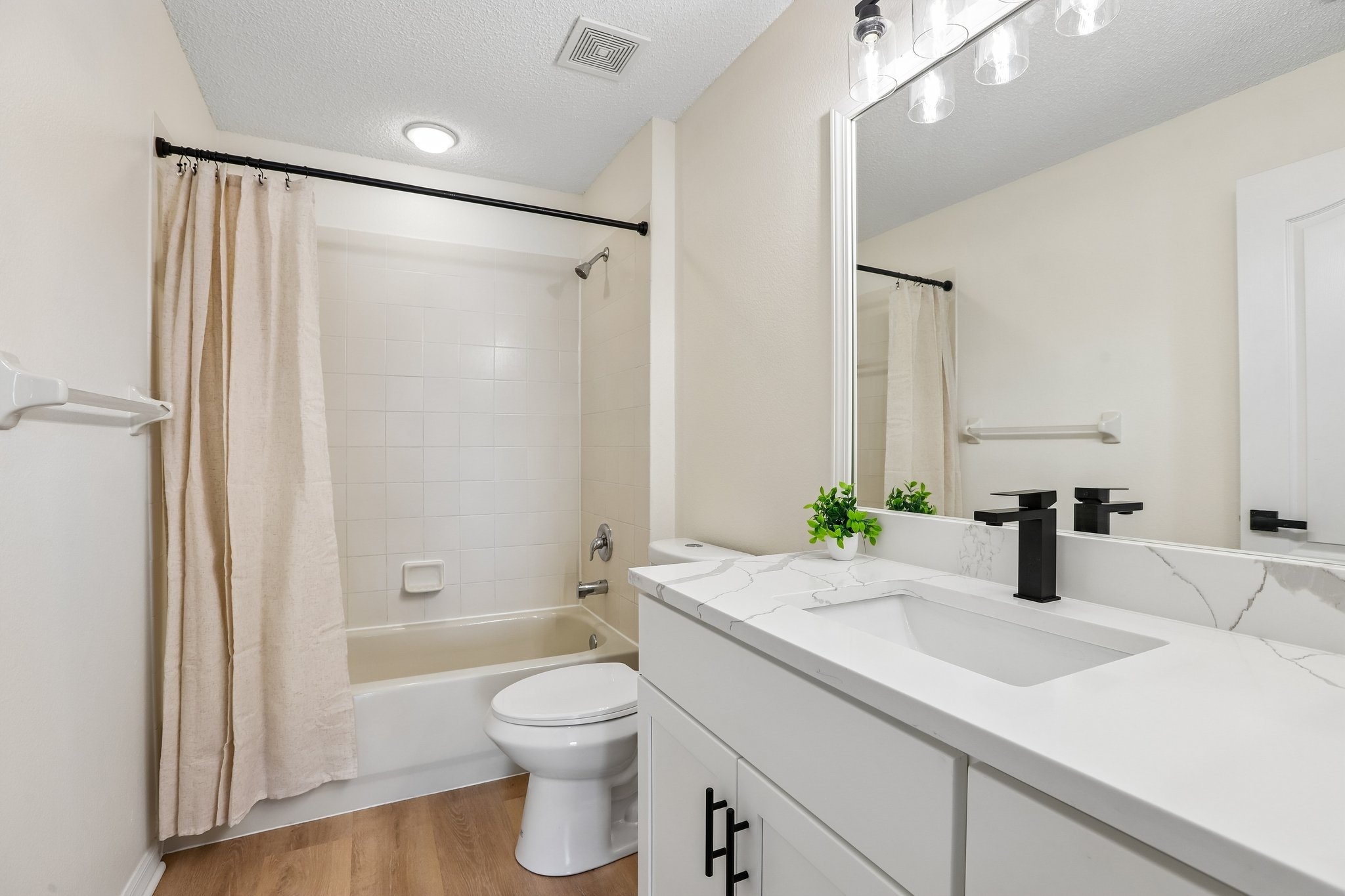 Updated guest bathroom with tub shower and modern vanity at 2638 Big Pine Dr, Holiday FL
