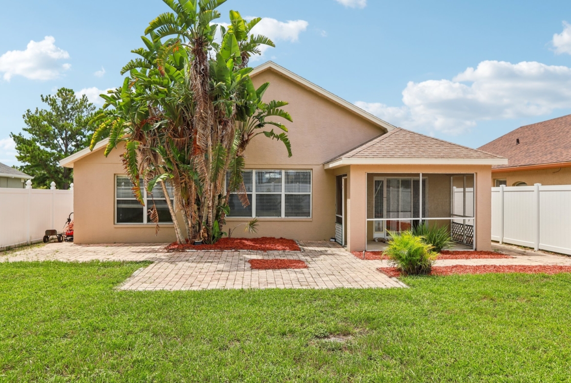 Front of home with mature landscaping in the gated Key Vista community of Holiday FL