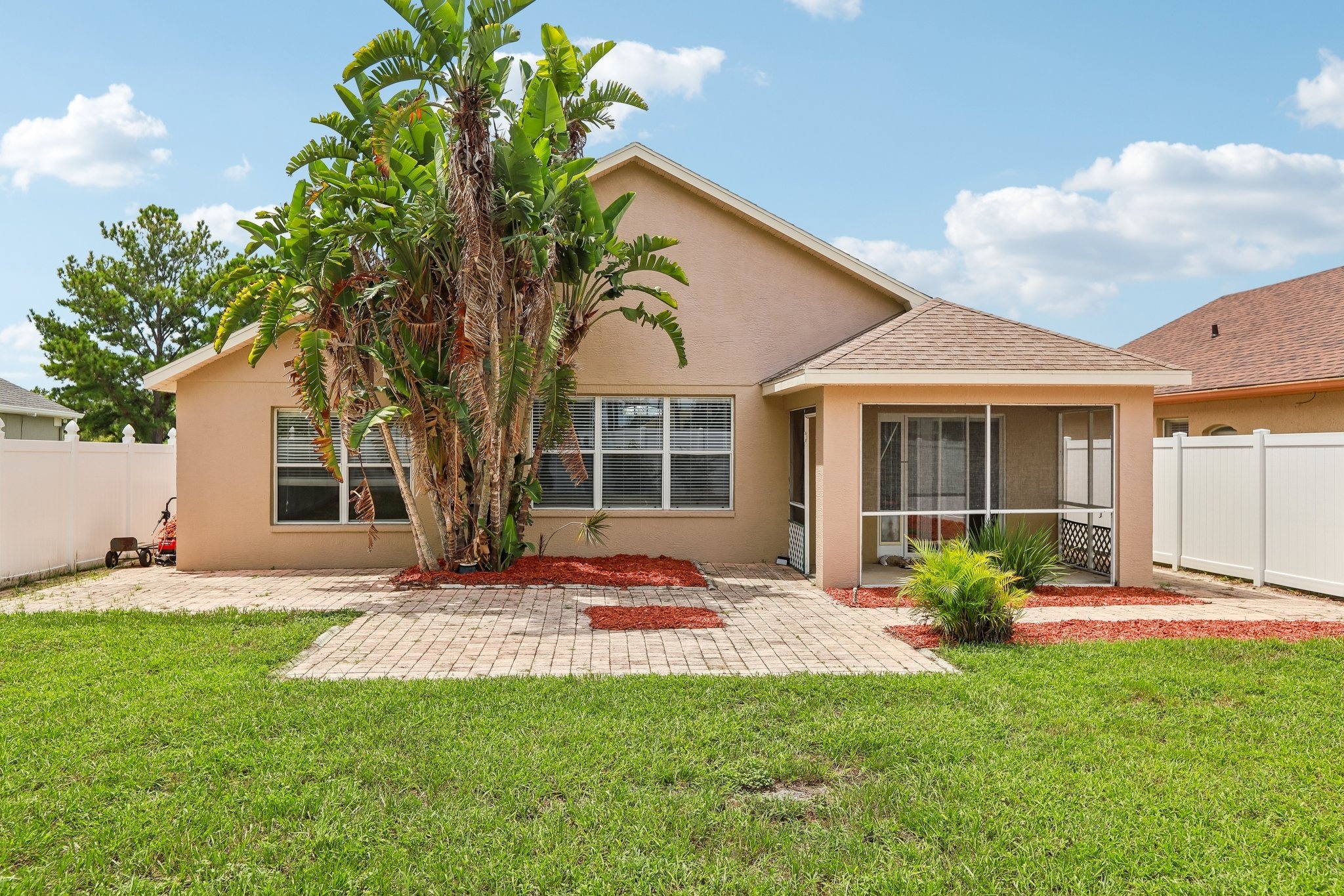 Front of home with mature landscaping in the gated Key Vista community of Holiday FL