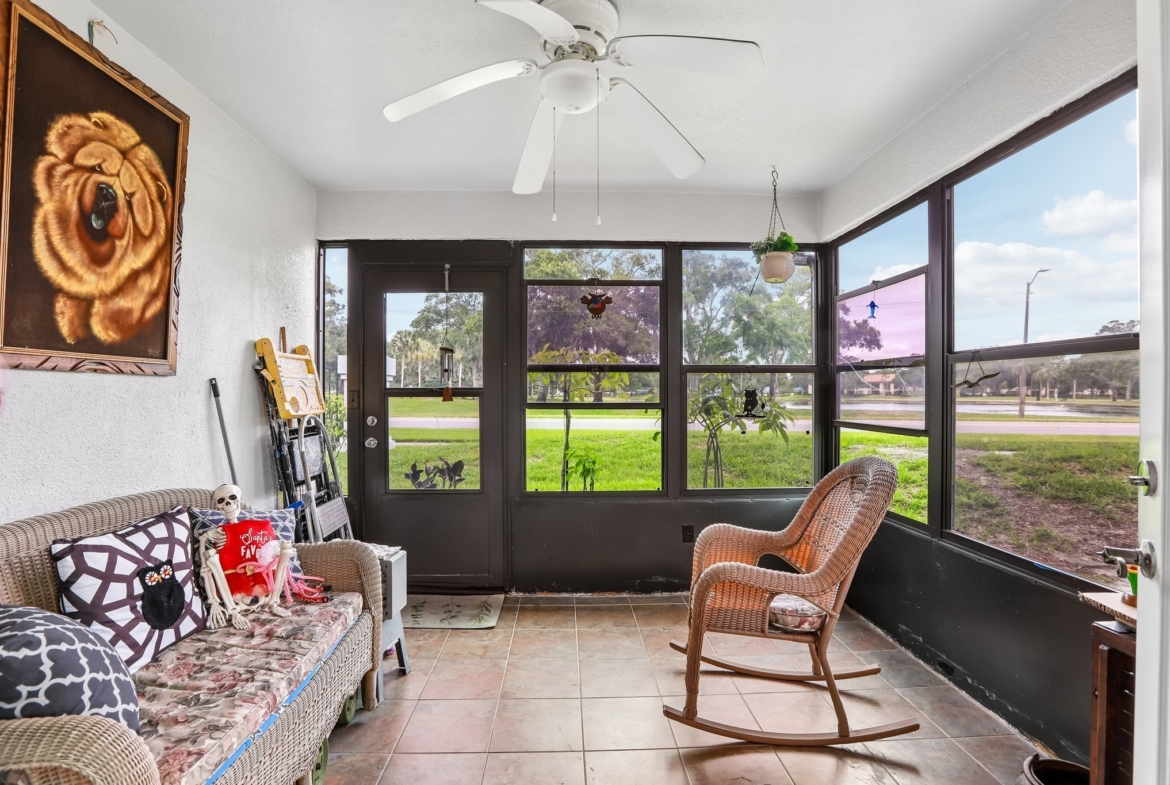 Enclosed lanai overlooking Crystal Lake and the park at 3878 Tanager Pl, Palm Harbor FL