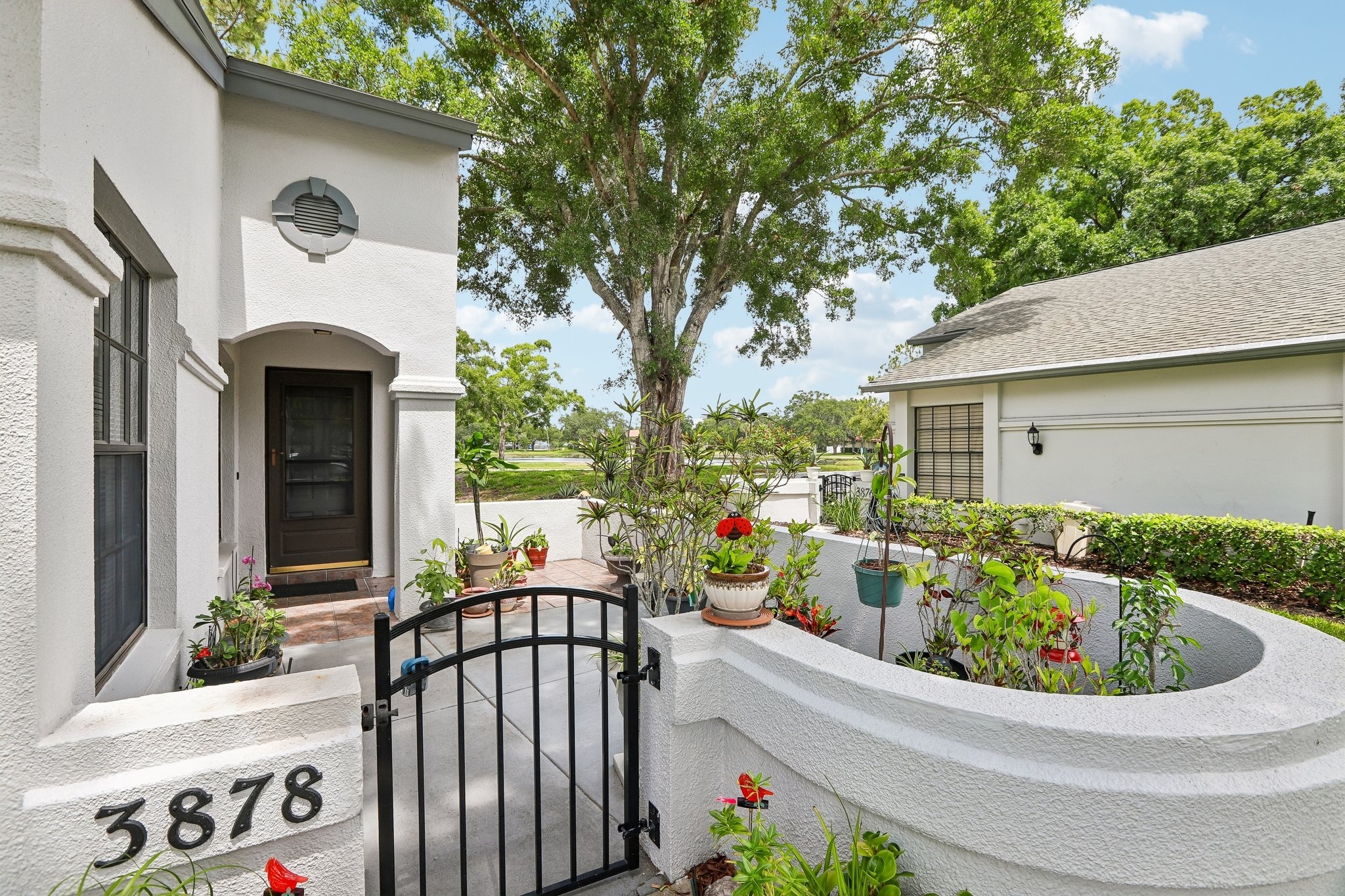 Front exterior of this end-unit villa with gated courtyard in Palm Harbor, FL 34685