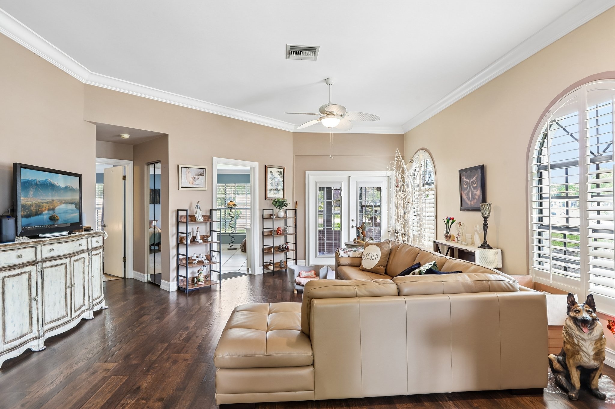 Living room with French doors to the enclosed lanai at 3878 Tanager Pl, Palm Harbor FL