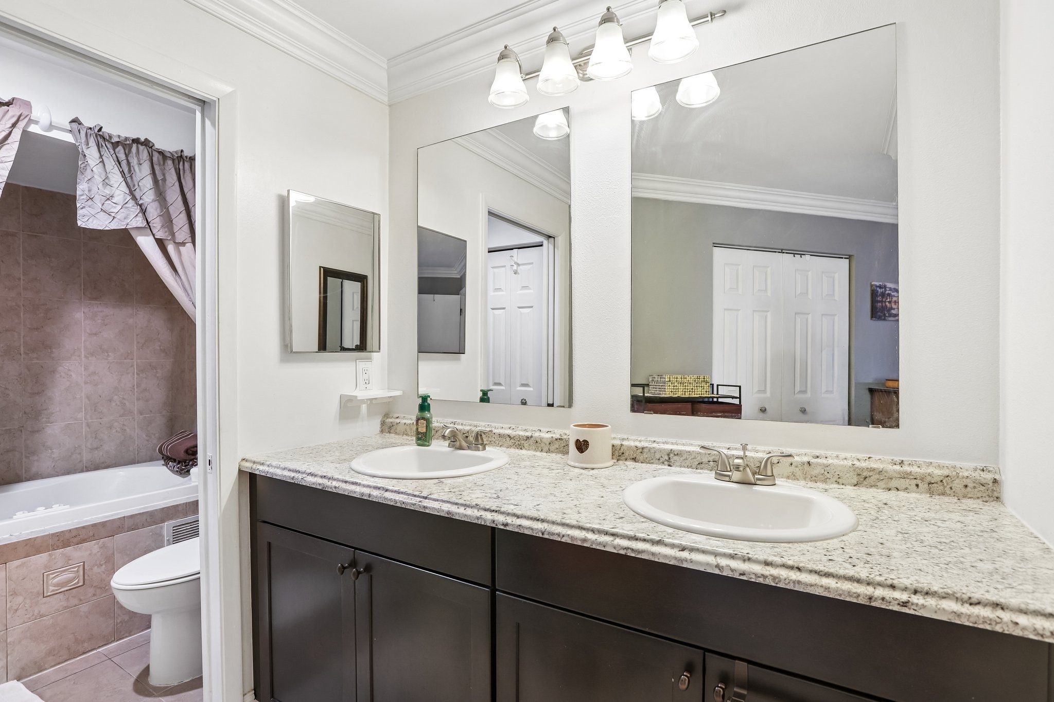 Primary bathroom with double vanity and ceramic tile at 3878 Tanager Pl, Palm Harbor, FL 34685