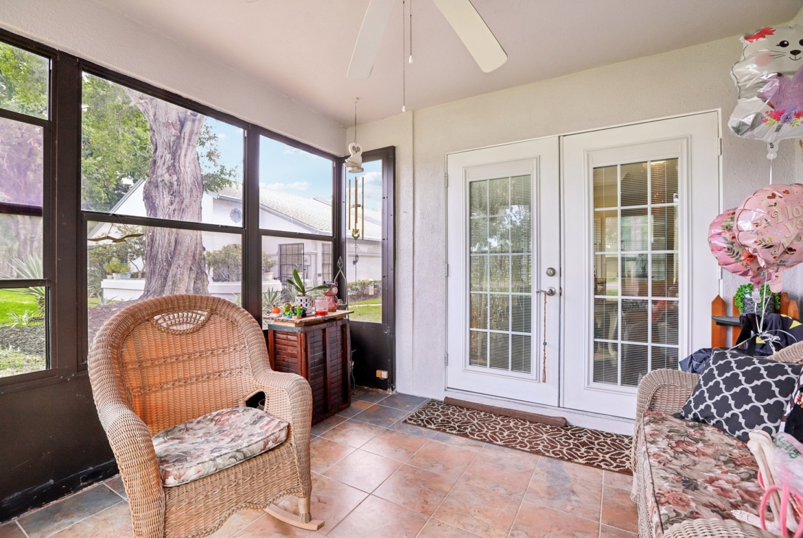Enclosed lanai with French doors and park views at 3878 Tanager Pl, Palm Harbor FL