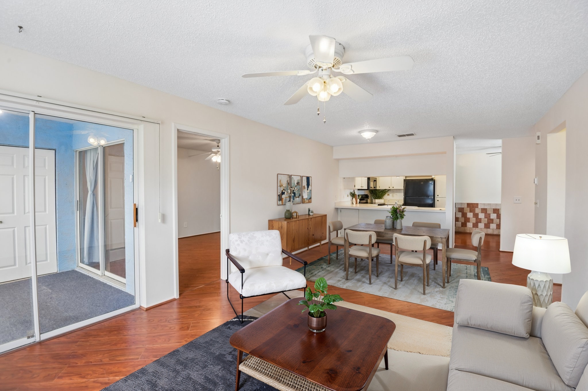 Bright living room with ceiling fan and open layout at 7713 Hillside Ct #204, Hudson FL